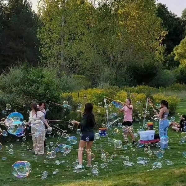 Children enjoying a bubble party with giant bubbles outdoors