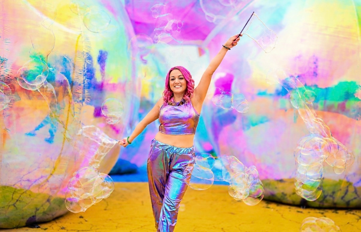 Bubble Bri performing with colorful iridescent bubbles